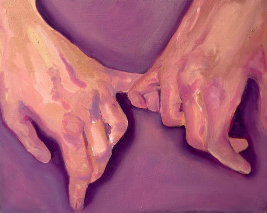 Close-up of two hands holding each other against a purple background